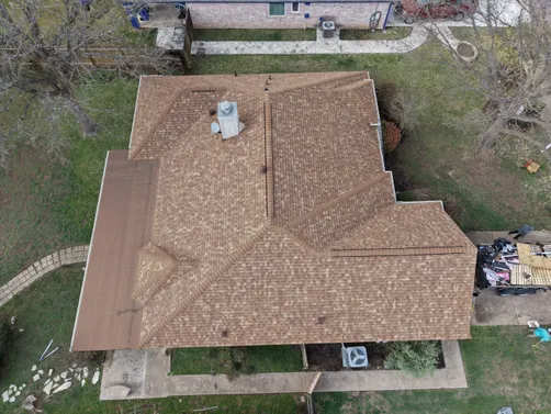 Overhead view of a tan shingle roof from Zilker Roofing’s Desert Tan replacement project